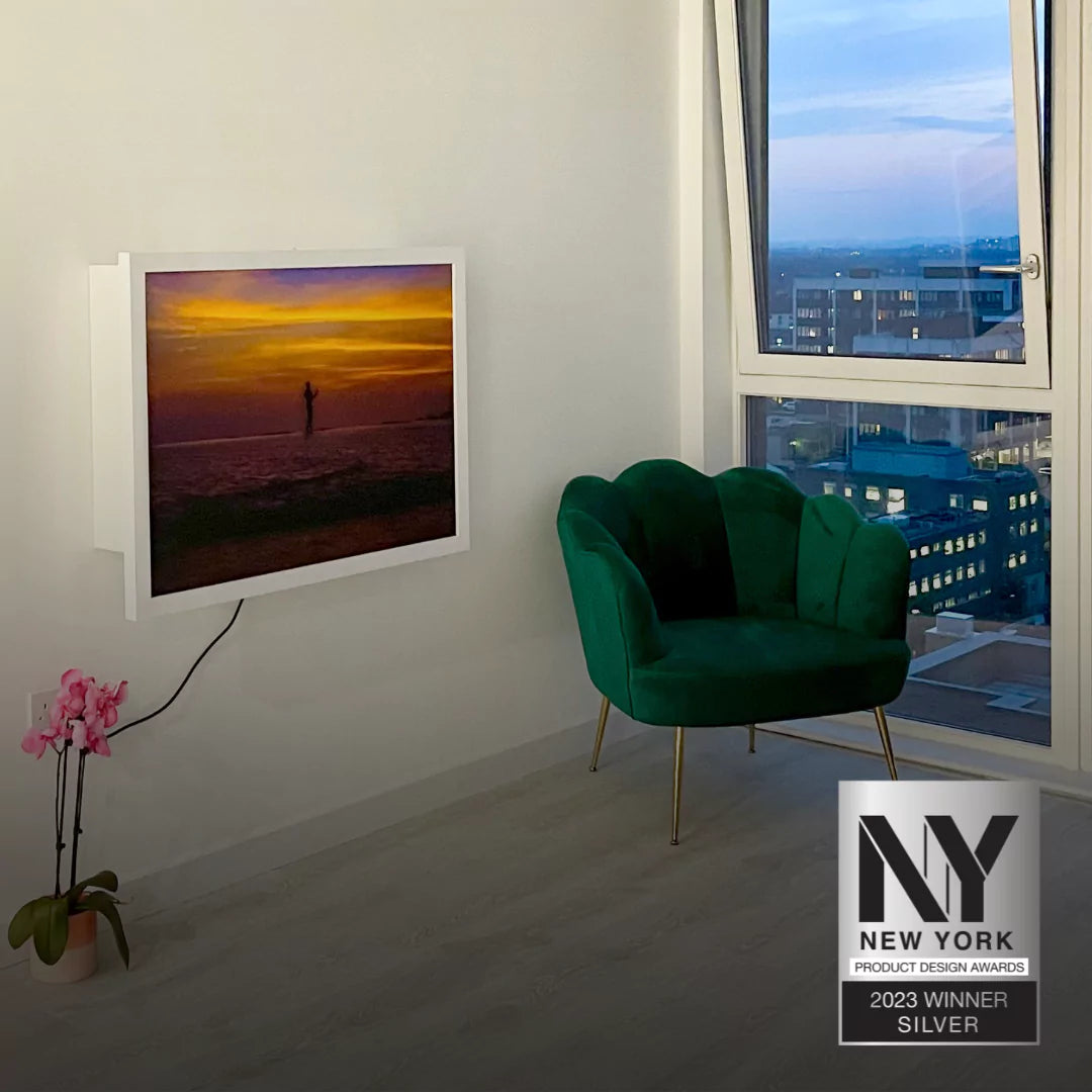 A closed DropTop desk showing artwork on a wall, with the New York Product Design Awards 2023 Silver Winner badge