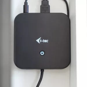 Compact i-tec docking station with its cables plugged in.