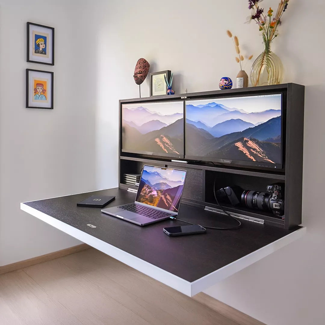 Open DropTop desk with two monitors, a laptop and a camera on the desktop.