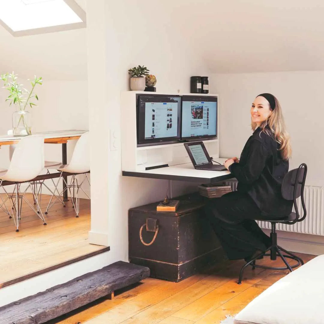 Woman working at an open DropTop desk in a period home with wooden floors.