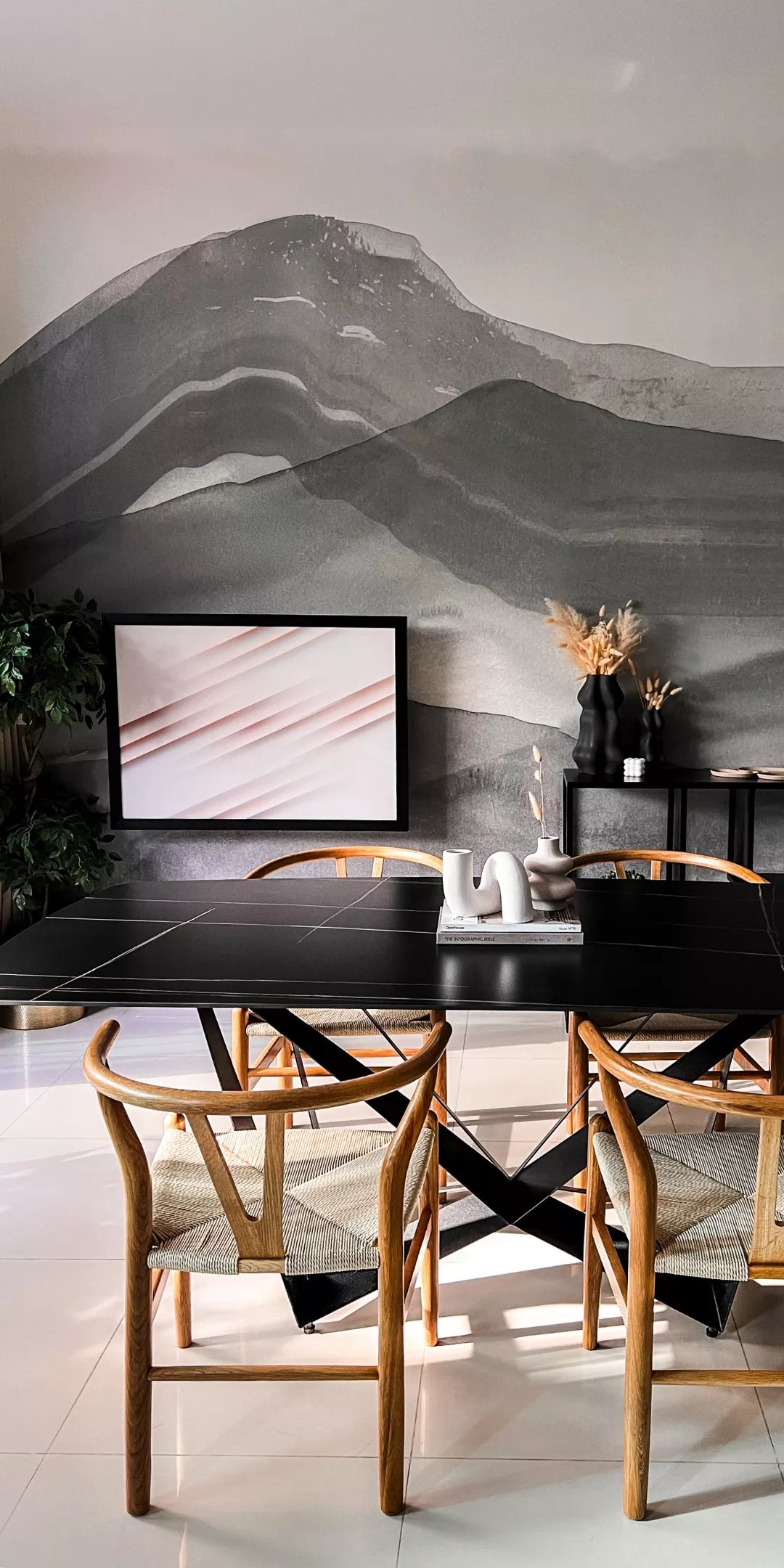 Dining room with a closed DropTop desk hanging as framed artwork above a black table and wooden chairs.