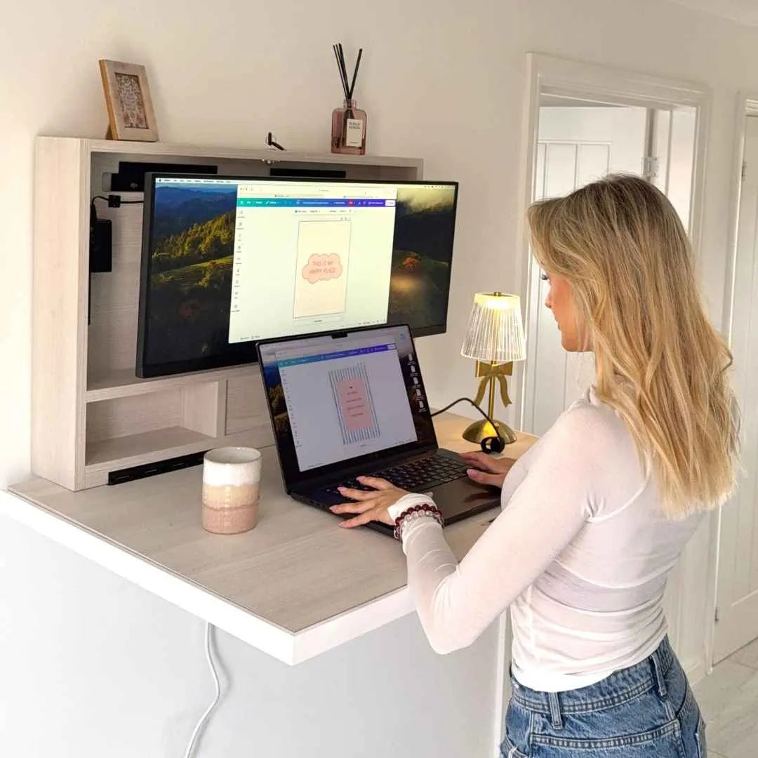 Woman standing at an open DropTop Classic using a laptop and monitor.