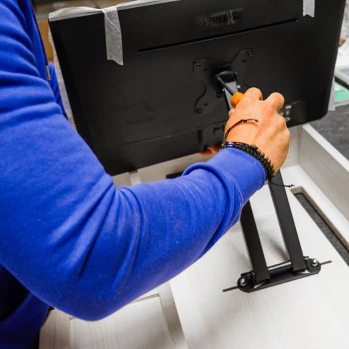 Hand assembly of a DropTop desk unit