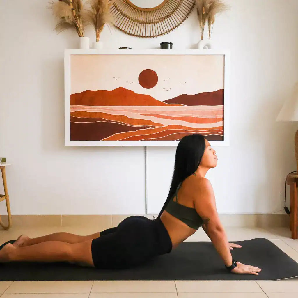 Woman doing a cobra stretch on a mat below a closed DropTop Duo 24.