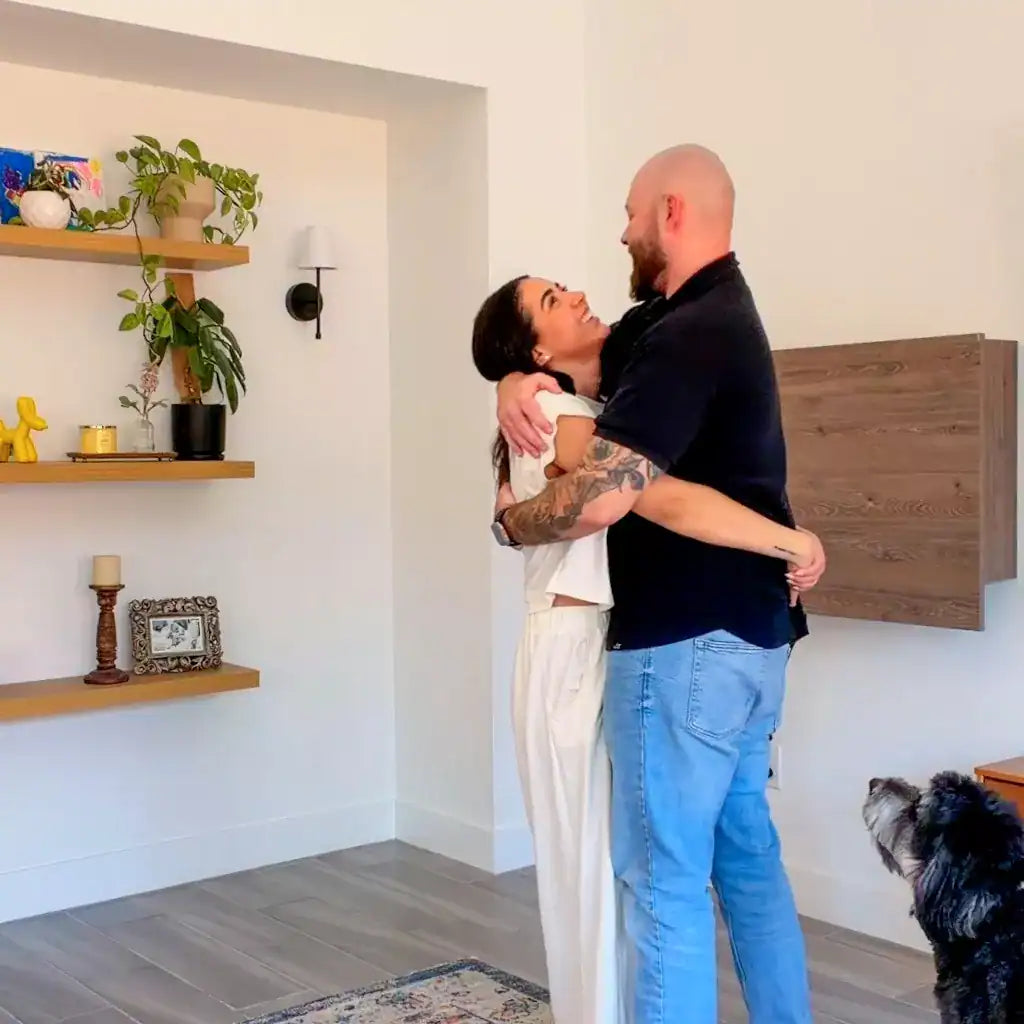 Couple embracing in front of a closed walnut DropTop Duo 24 Light.