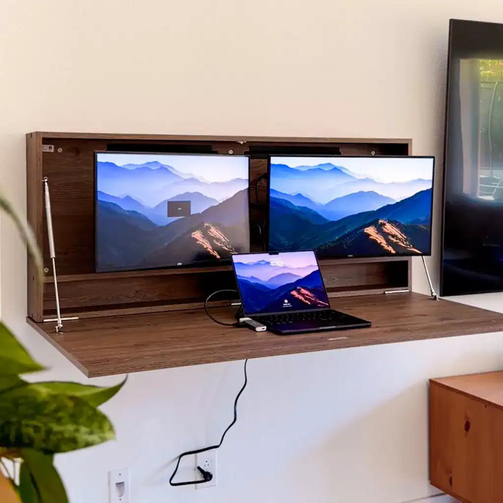 Open walnut DropTop Duo 24 Light with two mountain-wallpaper monitors and a laptop.