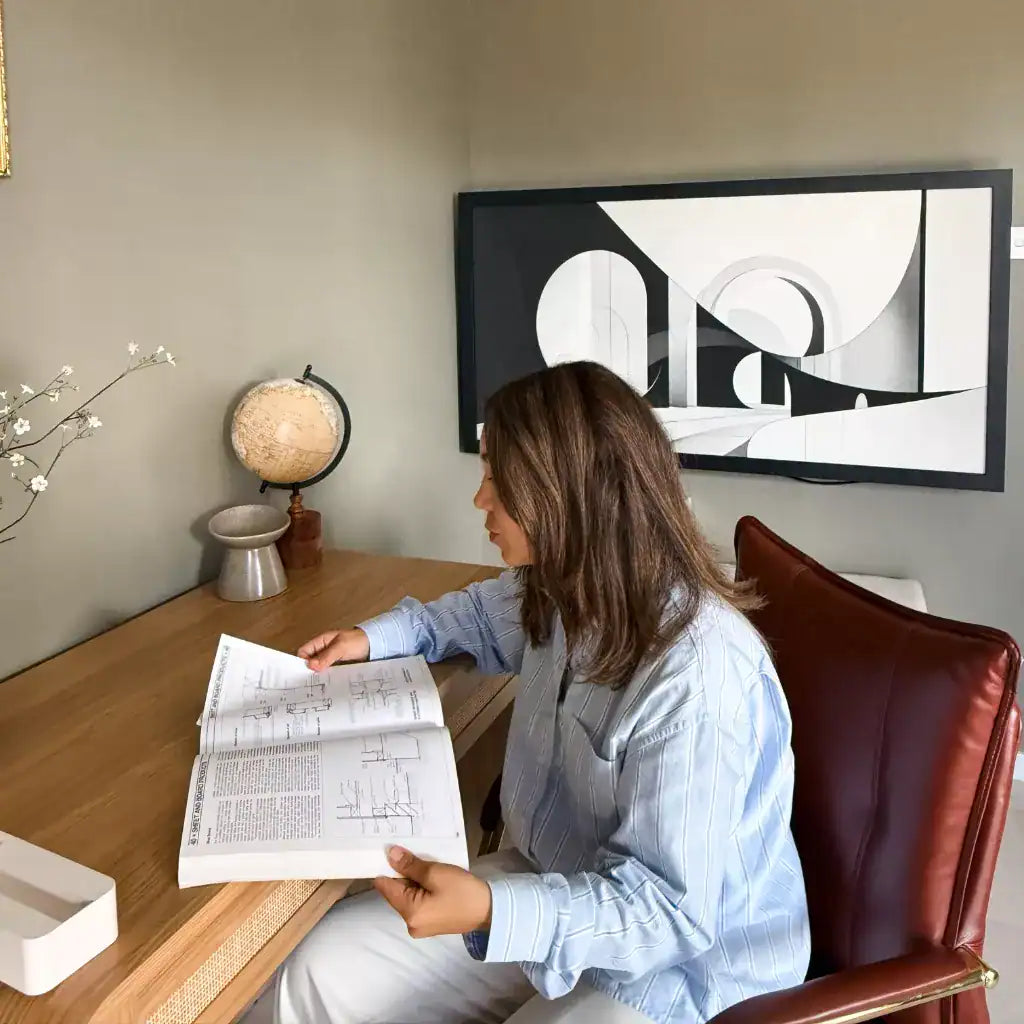 Woman reading a large book at an open DropTop Duo 27.