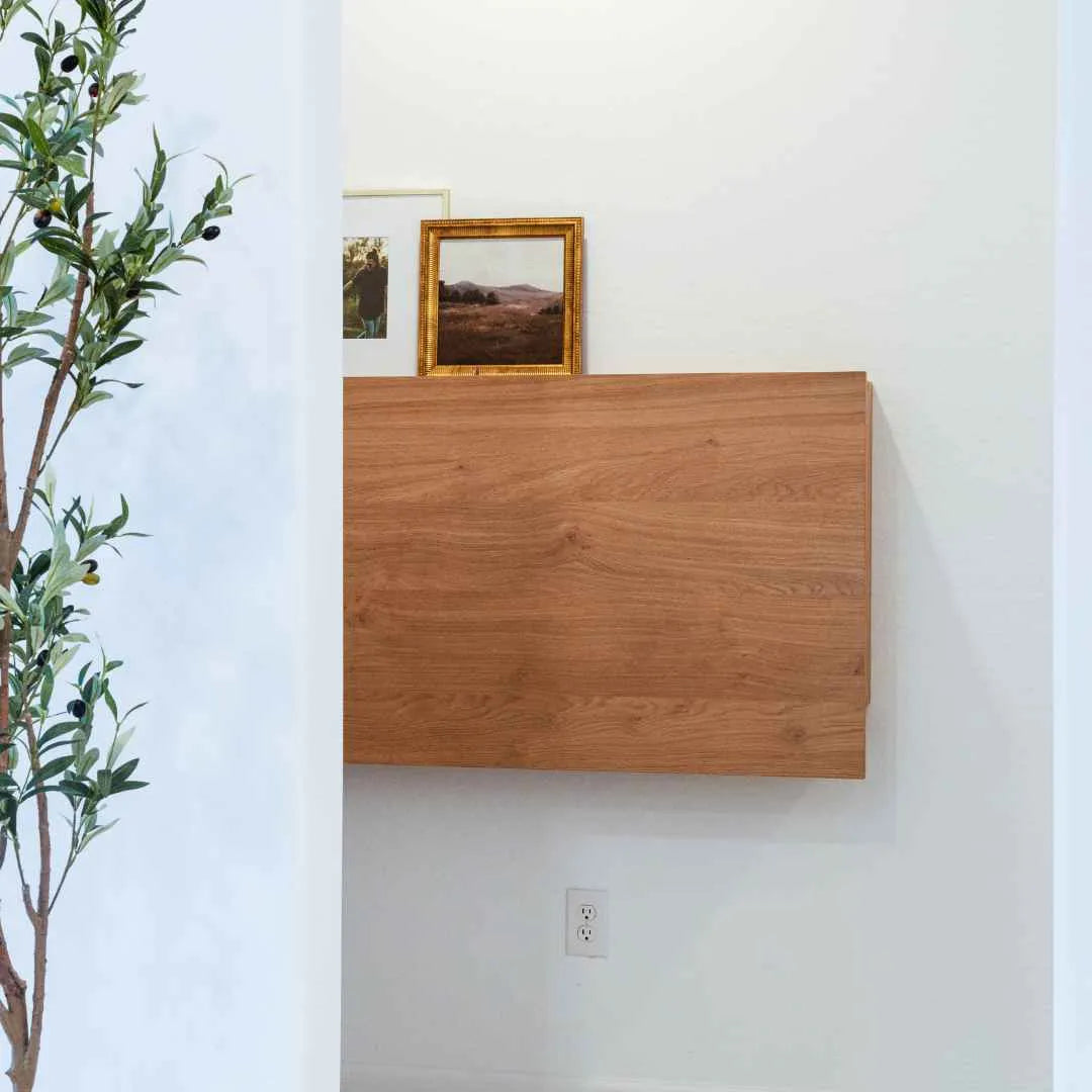 Closed oak DropTop Duo 27 Light on a panelled white wall.