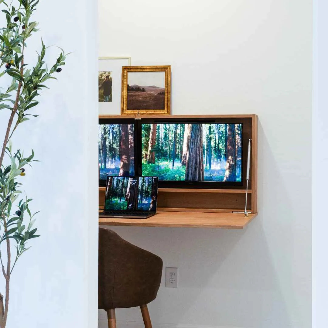 Open oak DropTop Duo 27 Light with two forest-scene monitors and a laptop.