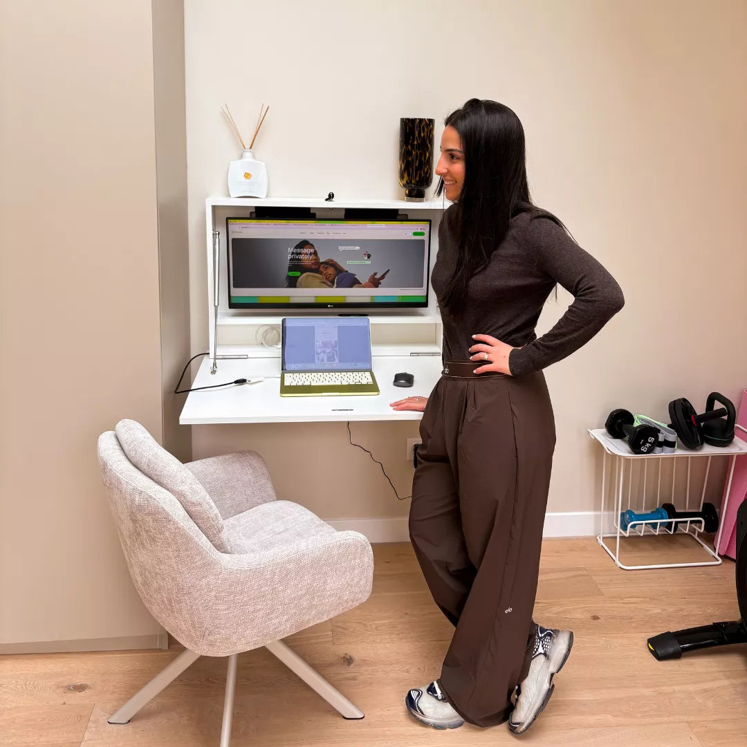 Woman standing beside an open white DropTop Single 29 Light with a monitor and laptop.