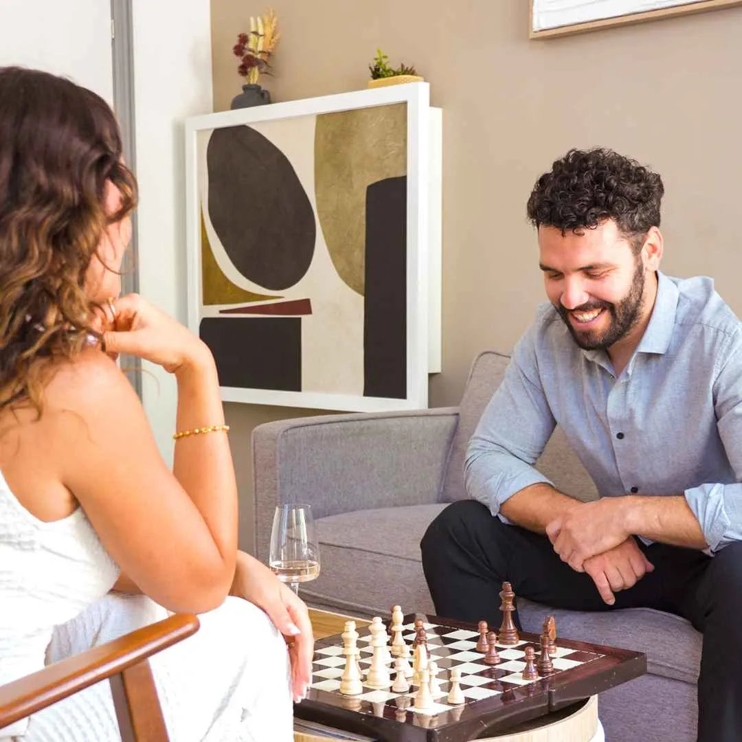 Couple playing chess in front of a closed DropTop Single 32 with an abstract front.