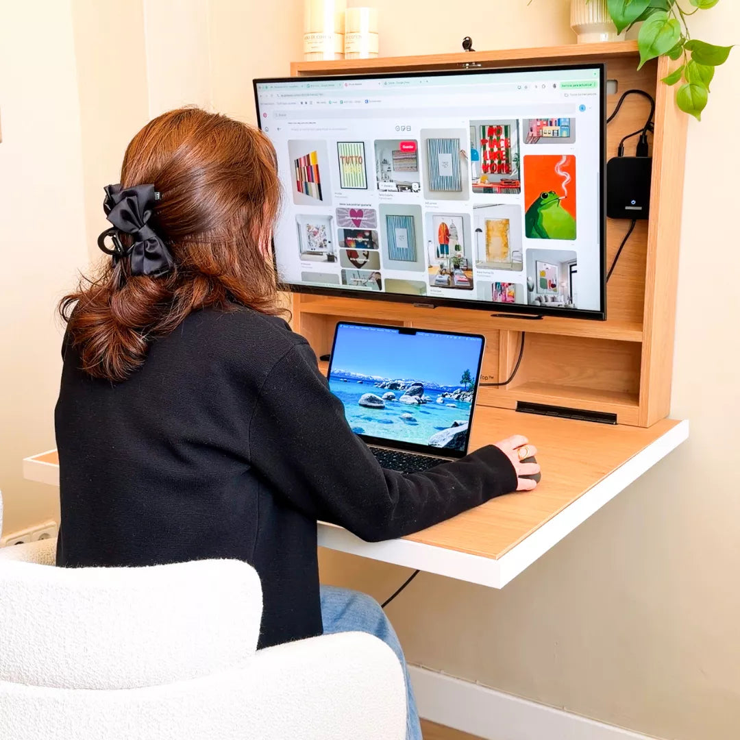Woman working at an open oak DropTop Single 32 with one monitor and a laptop.