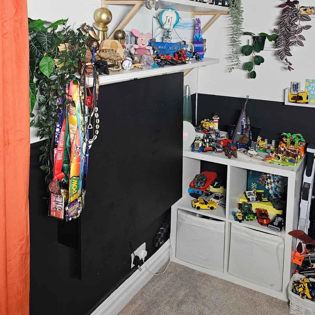 Closed black DropTop Single 32 Light in a child's room full of toy cars and models.
