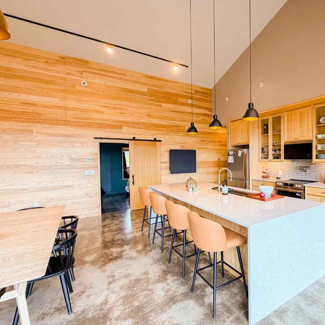 Closed dark DropTop Single 32 Light on a timber wall in an open-plan kitchen.