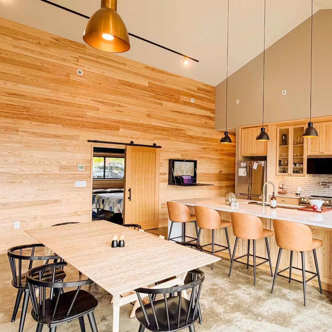 Open DropTop Single 32 Light on the far wall of a timber-clad kitchen diner.