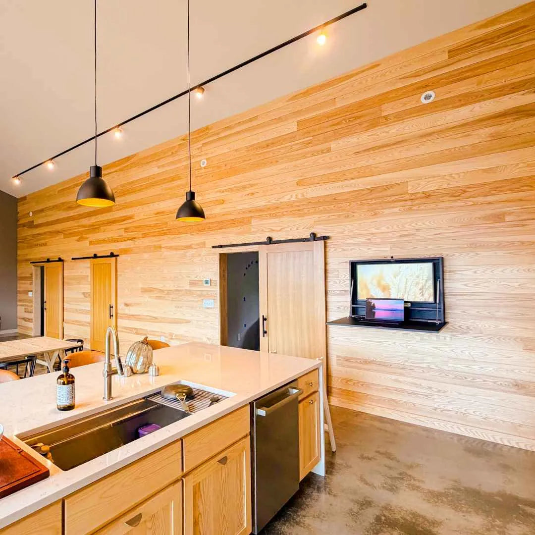 Open black DropTop Single 32 Light on a timber wall opposite a kitchen.