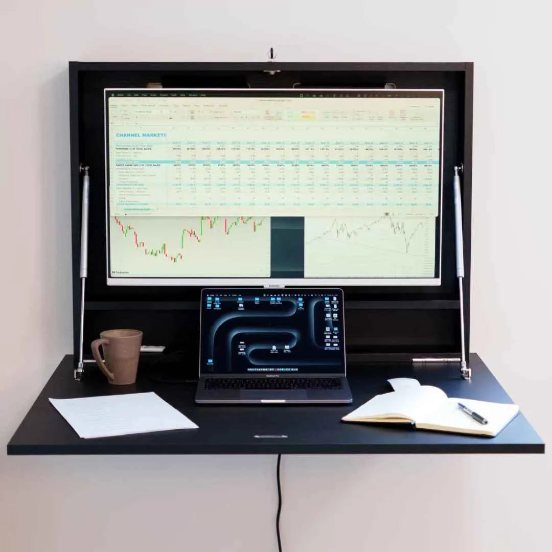 Close-up of an open black DropTop Single 32 Light with a trading chart on the monitor.