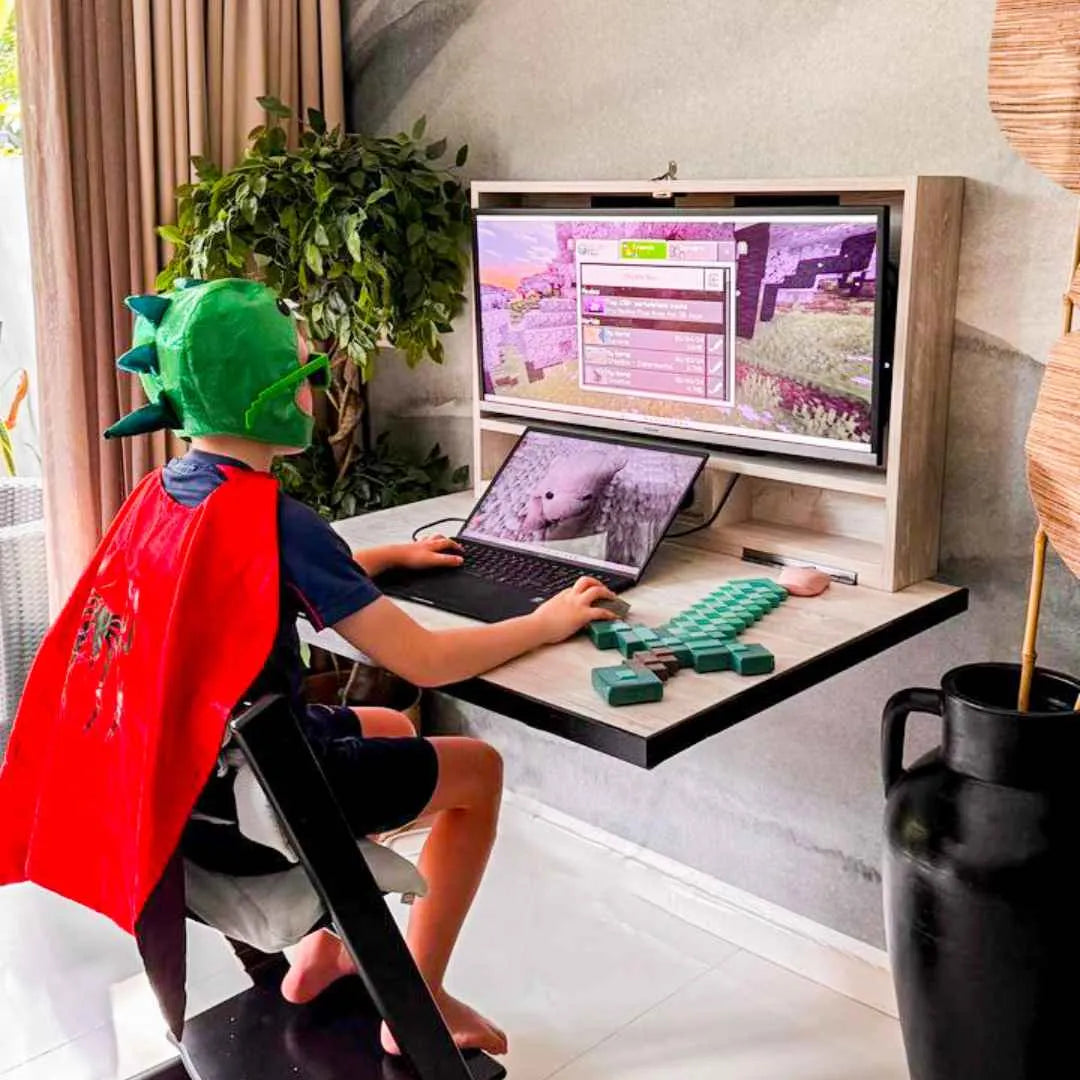 Boy playing a game at an open DropTop Single 34 with a monitor and laptop.
