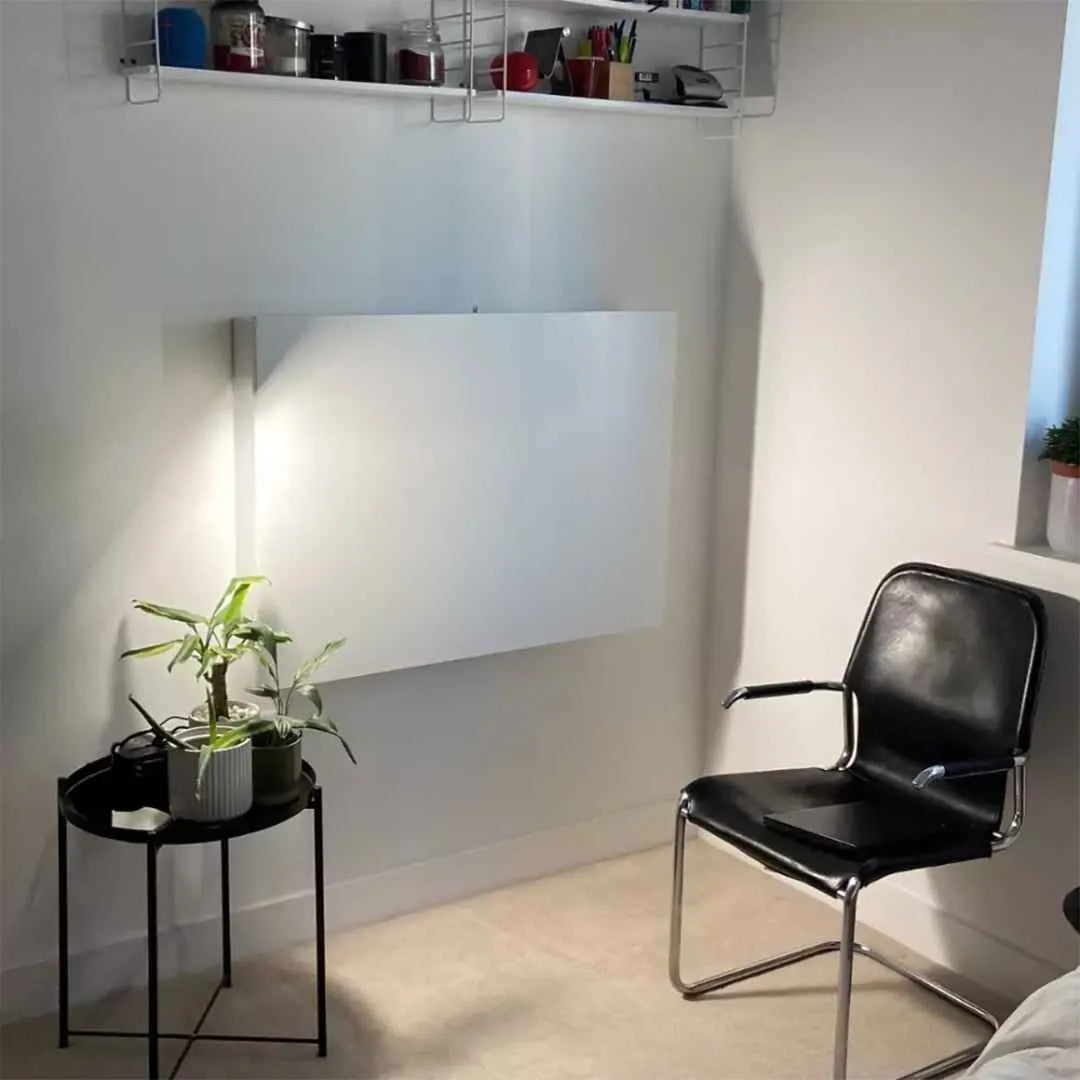 Closed white DropTop Single 34 Light on a corner wall beside a leather chair.